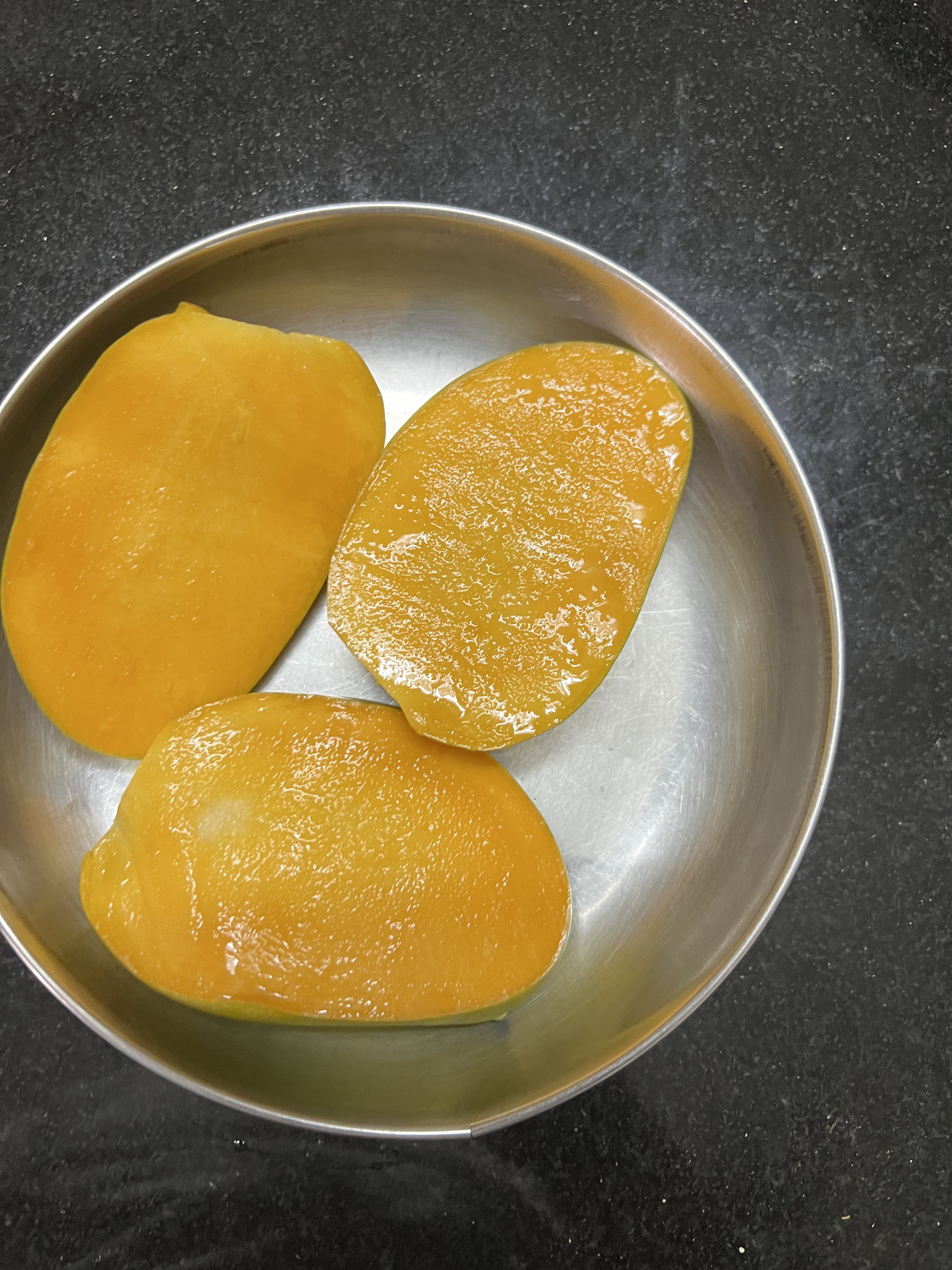 Mangoes ripened after storage showing bright orange flesh